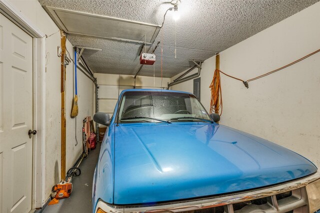 garage with a garage door opener and electric panel