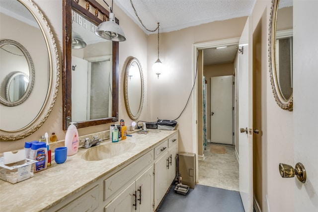 bathroom with a textured ceiling and vanity