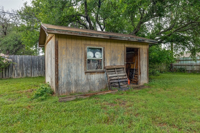 view of outbuilding featuring a yard