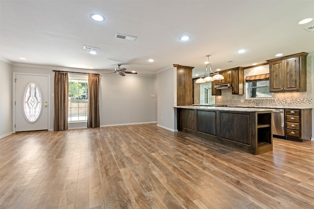 kitchen with ceiling fan, stainless steel dishwasher, hardwood / wood-style floors, decorative backsplash, and ornamental molding