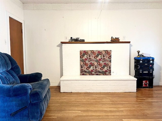 living area with a fireplace and hardwood / wood-style floors