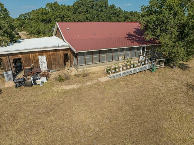 rear view of property with a sunroom