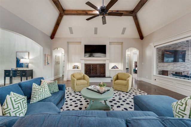 living room featuring hardwood / wood-style floors, beam ceiling, high vaulted ceiling, and ceiling fan