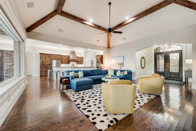 living room with french doors, ceiling fan, dark wood-type flooring, beam ceiling, and high vaulted ceiling