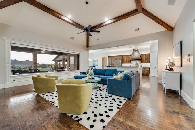 living room with dark wood-type flooring, ceiling fan, high vaulted ceiling, and beamed ceiling