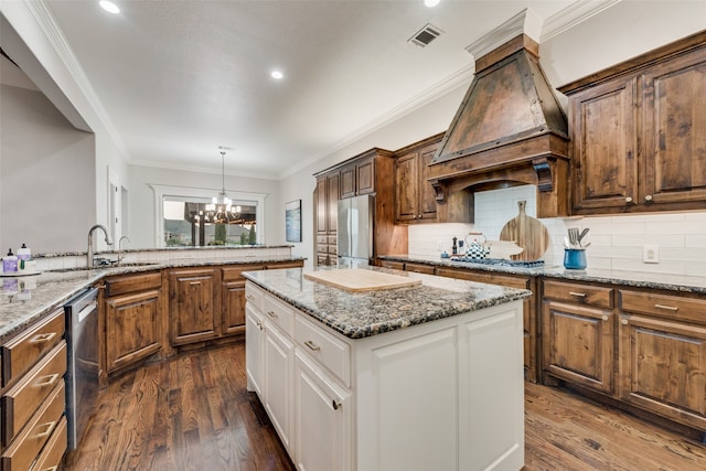 kitchen featuring dark hardwood / wood-style flooring, stainless steel appliances, white cabinets, a notable chandelier, and ornamental molding