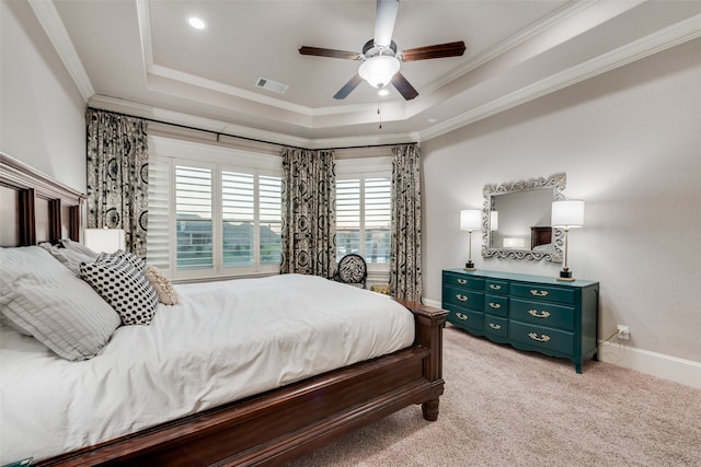 carpeted bedroom featuring crown molding, a tray ceiling, and ceiling fan