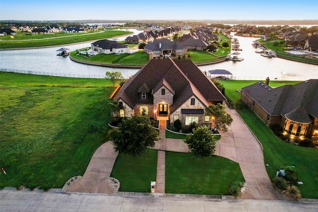 bird's eye view featuring a water view and a residential view