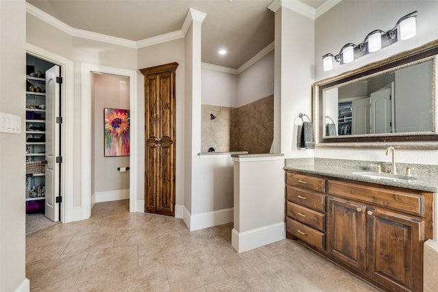 bathroom featuring vanity, ornamental molding, and a shower