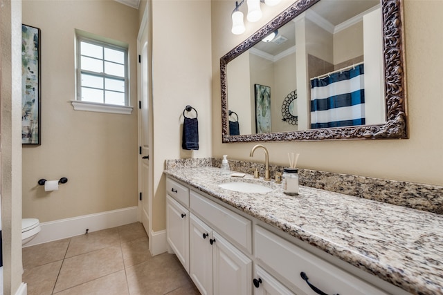 bathroom featuring vanity, toilet, ornamental molding, and tile patterned flooring