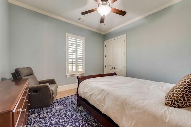 carpeted bedroom featuring a closet, ceiling fan, and ornamental molding