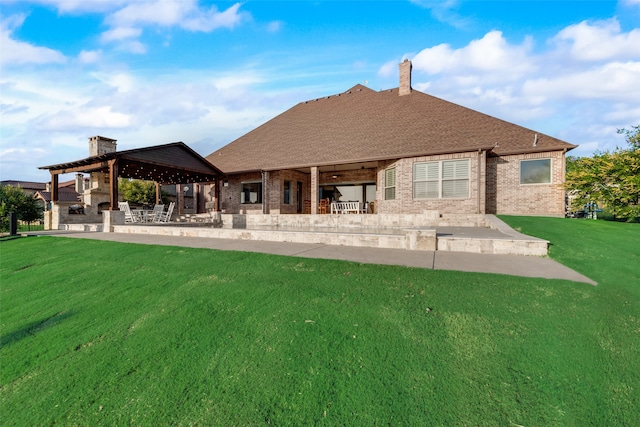 back of property with a patio area, a gazebo, and a lawn