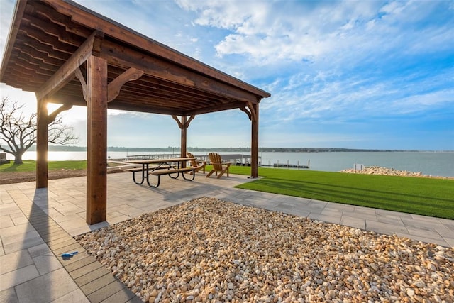 view of property's community featuring a patio area, a gazebo, a yard, and a water view