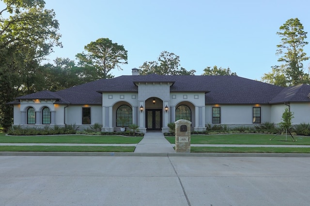 mediterranean / spanish-style house with a front lawn