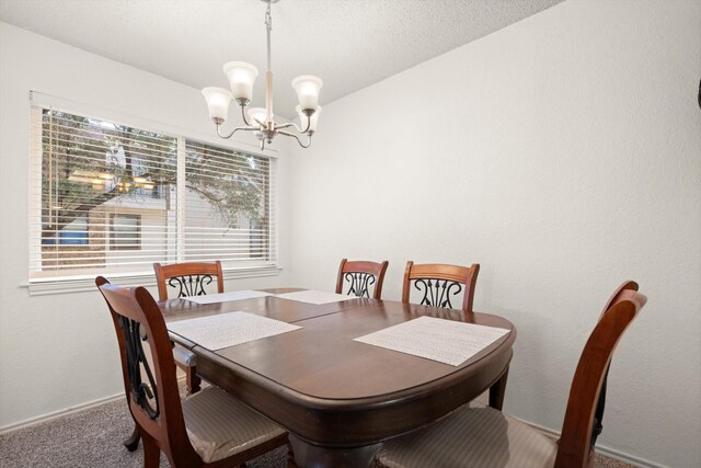 kitchen with decorative light fixtures, a chandelier, sink, vaulted ceiling, and appliances with stainless steel finishes