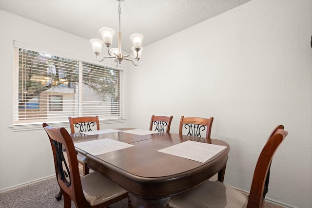 carpeted dining space featuring baseboards, a textured ceiling, and an inviting chandelier