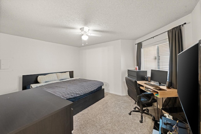 bedroom featuring carpet floors, ceiling fan, and a textured ceiling