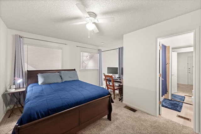 bedroom featuring a textured ceiling, ceiling fan, carpet flooring, and visible vents