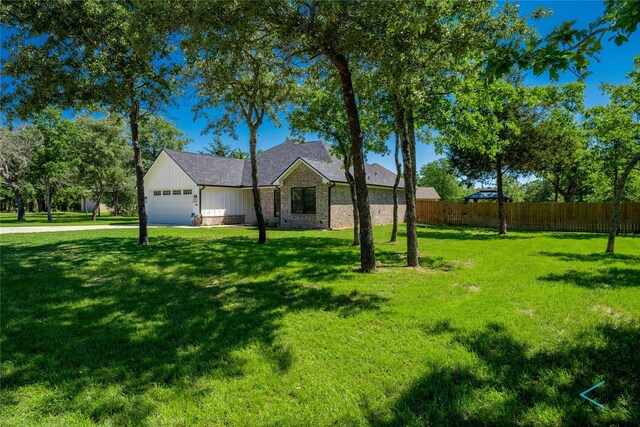 ranch-style home featuring a front yard and a garage