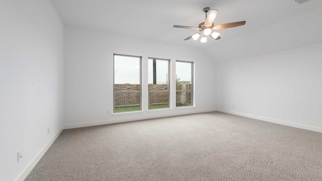 carpeted empty room with ceiling fan and lofted ceiling