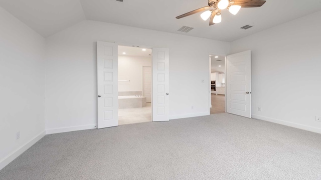 unfurnished bedroom featuring ceiling fan, carpet floors, and vaulted ceiling