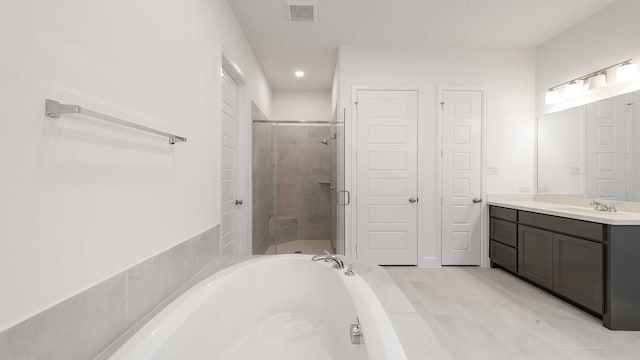 bathroom with tile patterned flooring, vanity, and independent shower and bath