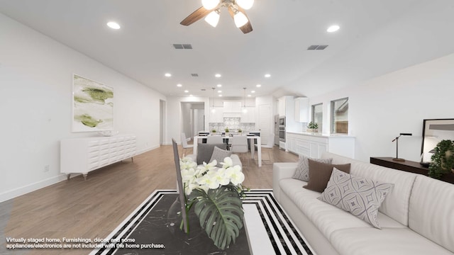 living room with ceiling fan and hardwood / wood-style floors