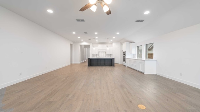 unfurnished living room with ceiling fan and light hardwood / wood-style flooring