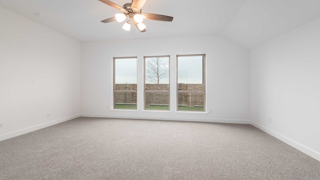 carpeted empty room with ceiling fan and lofted ceiling