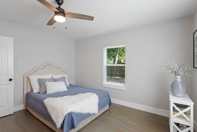 bedroom with ceiling fan and dark wood-type flooring