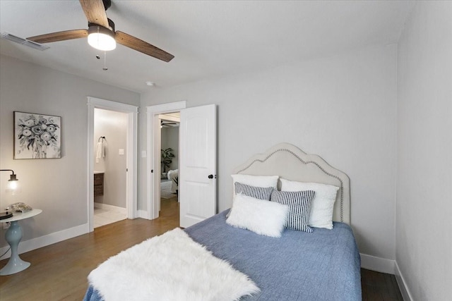 bedroom featuring ensuite bath, ceiling fan, and dark wood-type flooring