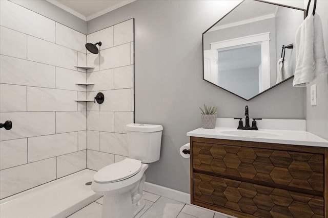 bathroom featuring tiled shower, vanity, toilet, and crown molding