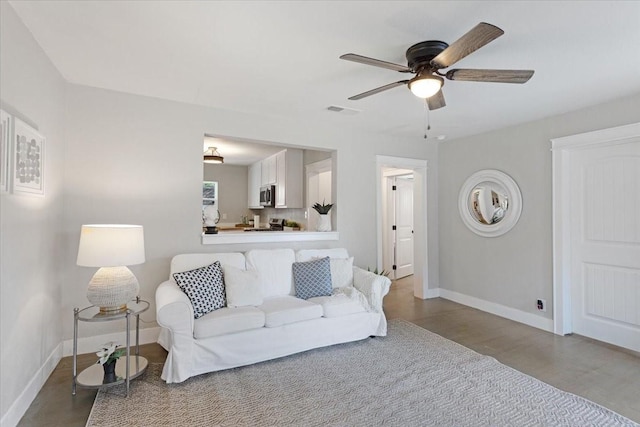 living room featuring light hardwood / wood-style flooring and ceiling fan