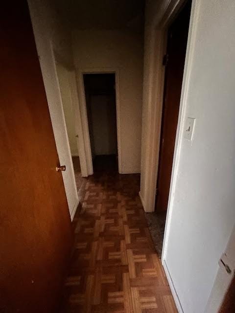 hallway featuring dark parquet floors