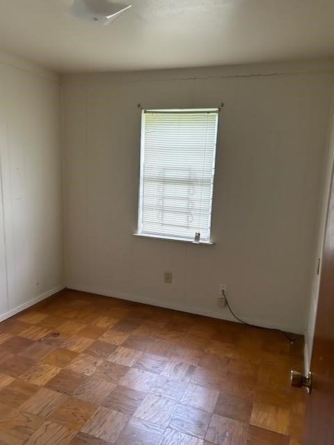 unfurnished room with parquet floors