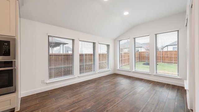 unfurnished sunroom featuring vaulted ceiling