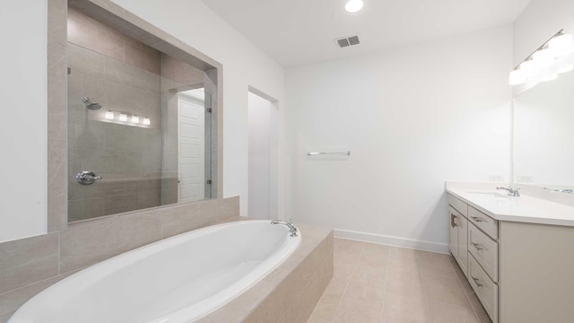 bathroom with tile patterned flooring, vanity, and independent shower and bath