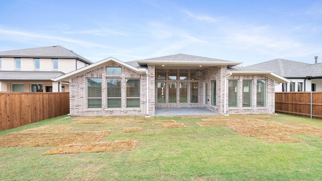 rear view of house featuring a patio area and a yard