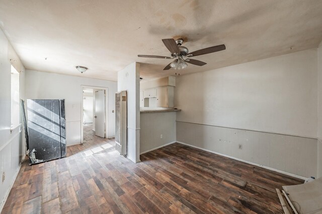 empty room with dark hardwood / wood-style floors and ceiling fan