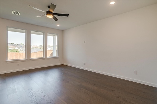 spare room featuring ceiling fan and dark hardwood / wood-style floors