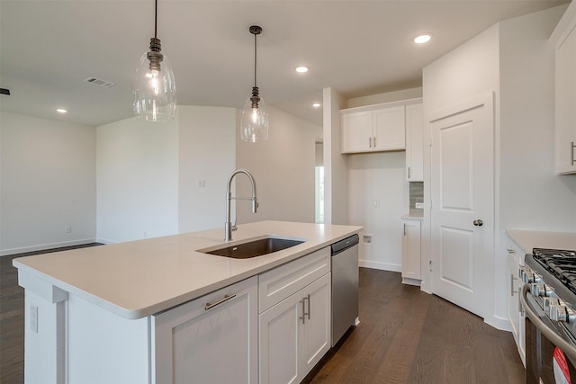 kitchen featuring white cabinetry, an island with sink, appliances with stainless steel finishes, and sink