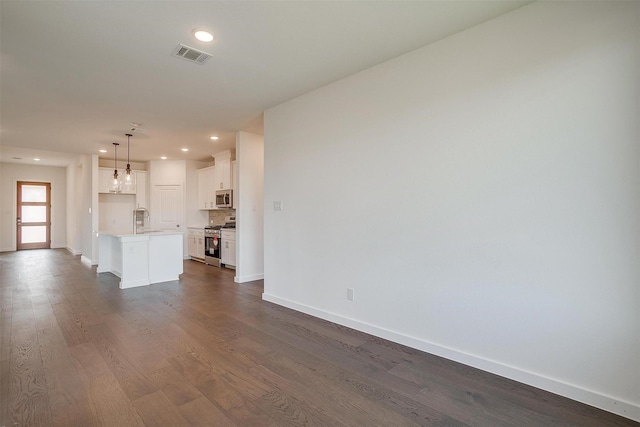 unfurnished living room featuring dark wood-type flooring and sink