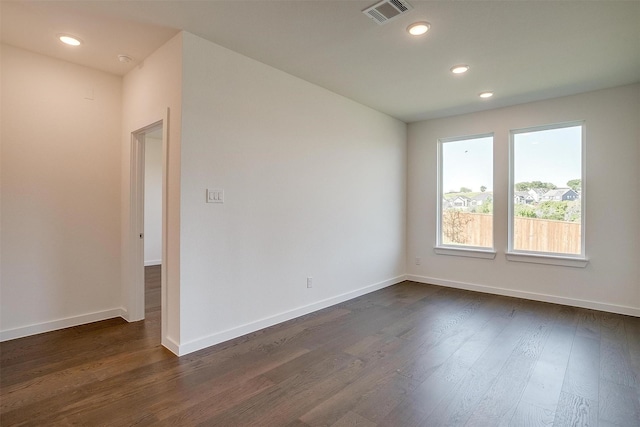 unfurnished room featuring dark wood-type flooring