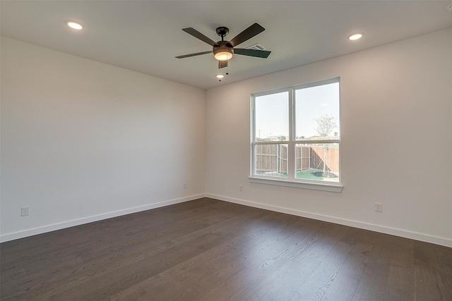 empty room with dark hardwood / wood-style floors and ceiling fan