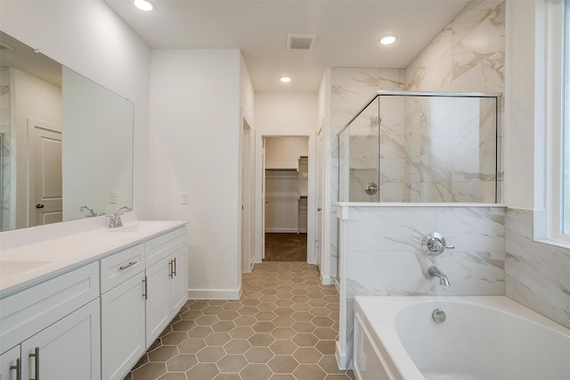 bathroom featuring vanity and separate shower and tub