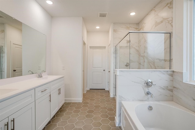 bathroom with vanity, tile patterned floors, and independent shower and bath