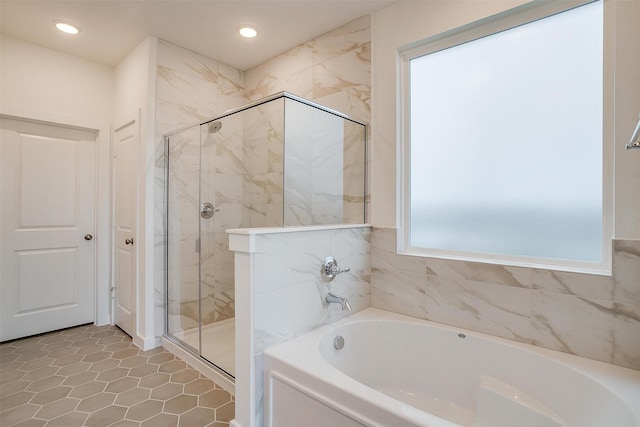 bathroom featuring independent shower and bath