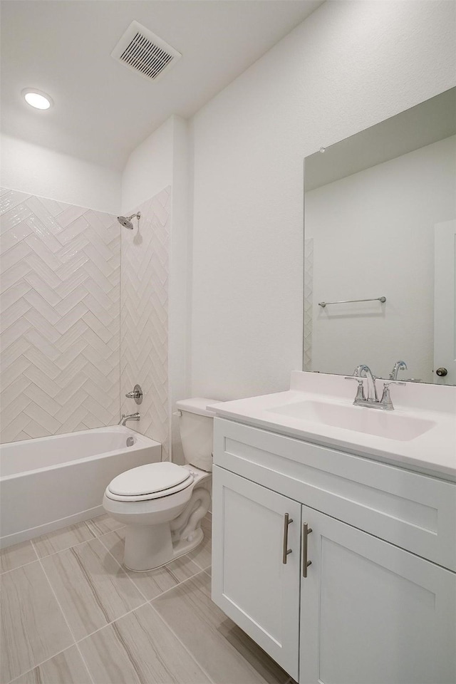 full bathroom with vanity, tiled shower / bath, and toilet