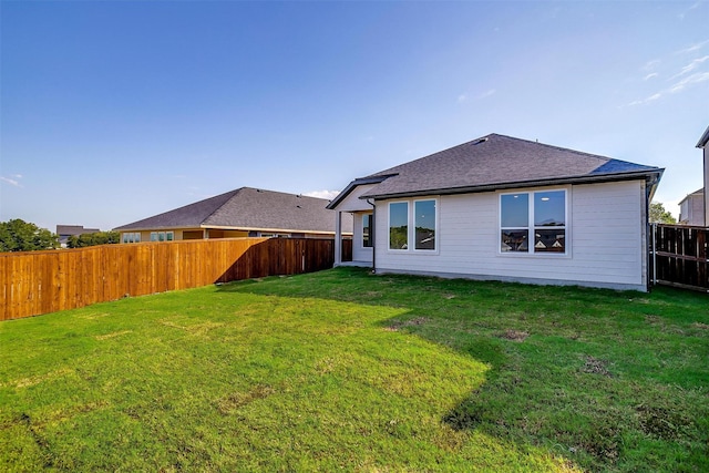 back of house featuring a yard