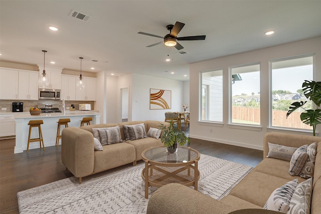 living room featuring hardwood / wood-style flooring and ceiling fan